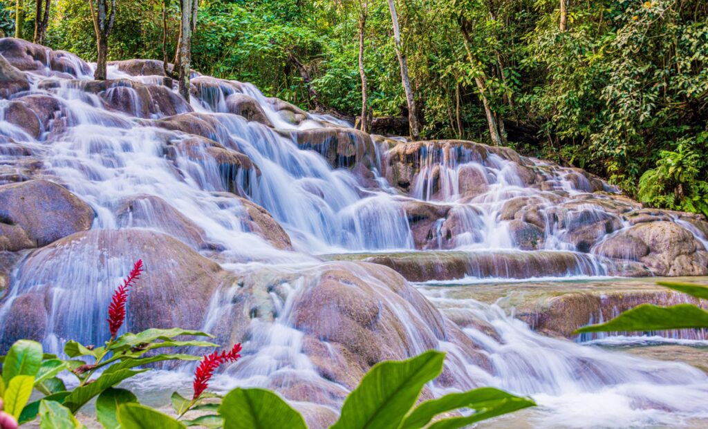 Cascading waterfalls surrounded by tropical greenery at Dunn’s River Falls in Ocho Rios, Jamaica